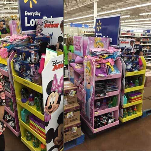 Retail aisle with a cardboard floor display positioned to interrupt shopper path.