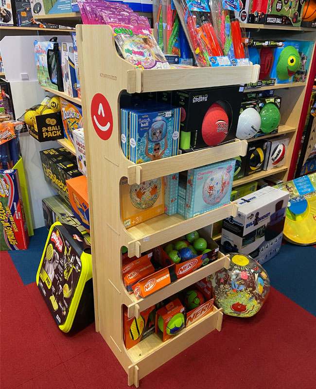 A hero shot of a vibrant, custom-designed corrugated cardboard display in a retail store